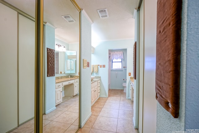 bathroom with tile patterned flooring, vanity, toilet, and ornamental molding