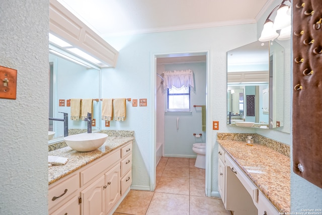 bathroom featuring tile patterned floors, crown molding, vanity, and toilet