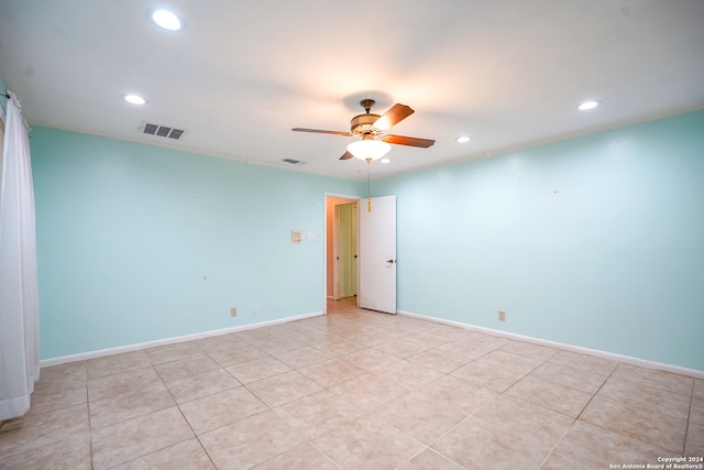 empty room with ceiling fan and light tile patterned flooring