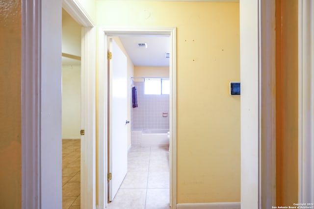 hall with light tile patterned floors