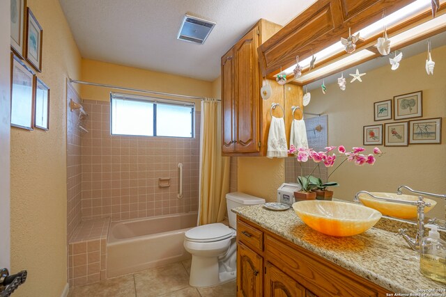 full bathroom with tile patterned floors, vanity, toilet, and shower / tub combo with curtain