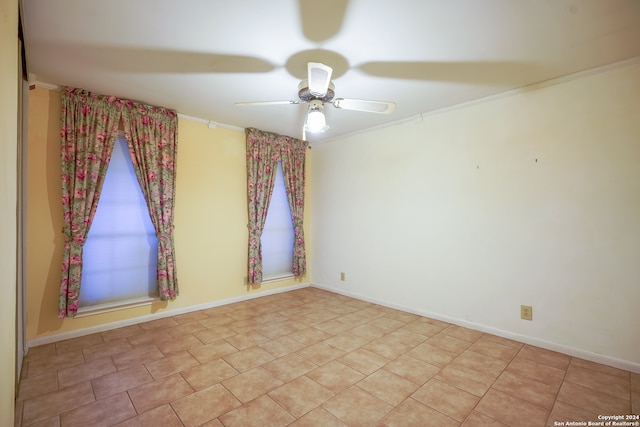 empty room with ceiling fan and crown molding