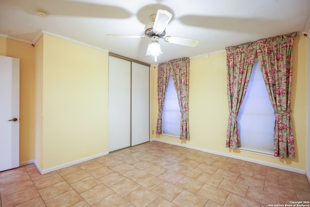 unfurnished room featuring ceiling fan and ornamental molding