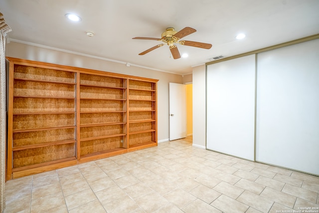 interior space with ceiling fan and crown molding