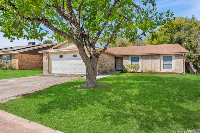 ranch-style home with a garage and a front lawn