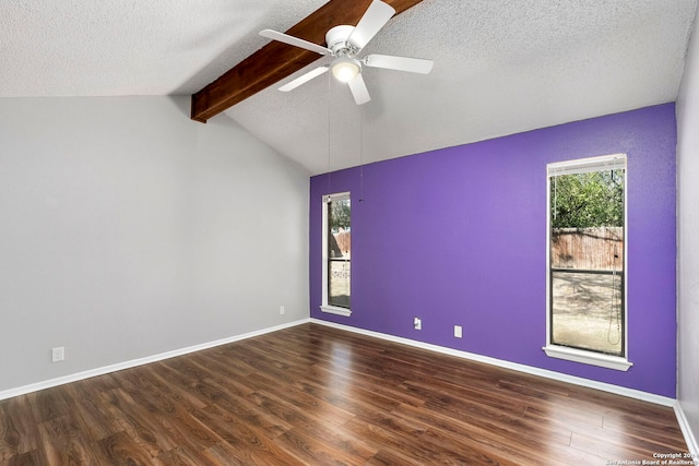 empty room with lofted ceiling with beams, dark hardwood / wood-style flooring, and ceiling fan