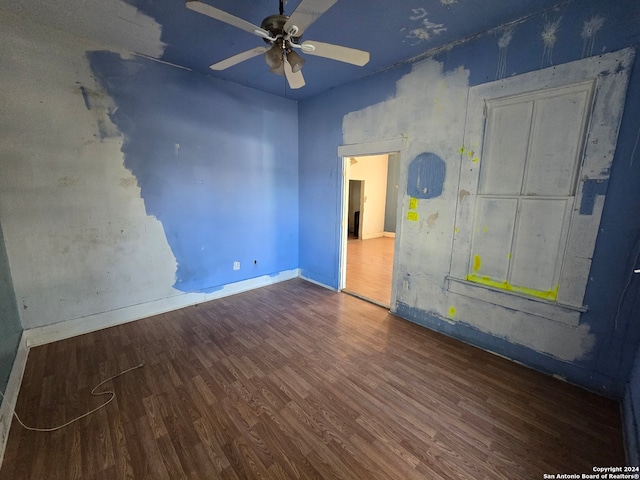 unfurnished room with ceiling fan and dark hardwood / wood-style flooring