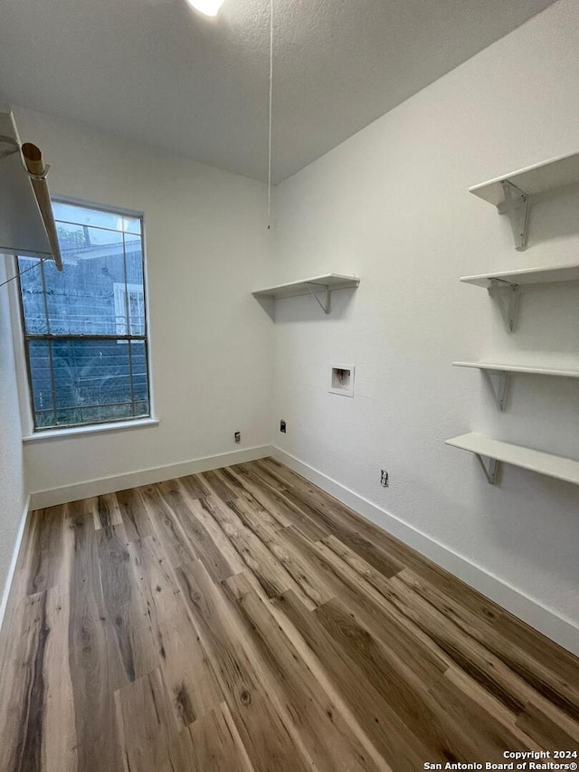 laundry area with wood-type flooring, hookup for an electric dryer, and hookup for a washing machine