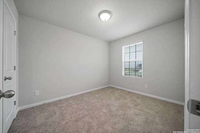 unfurnished room featuring carpet flooring