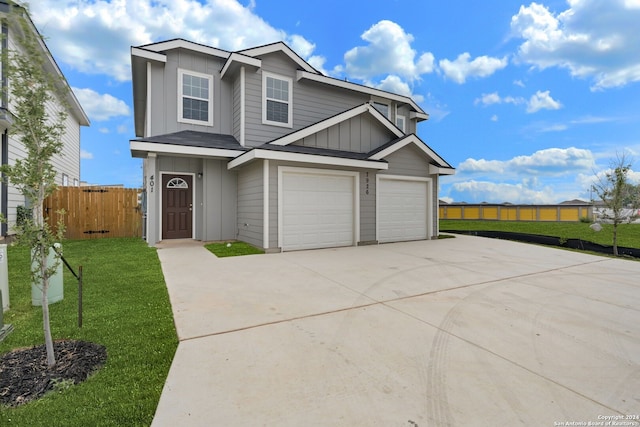 view of front of house with a front yard and a garage