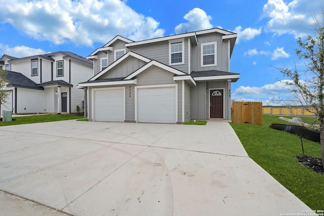 view of front of home with a front yard and a garage