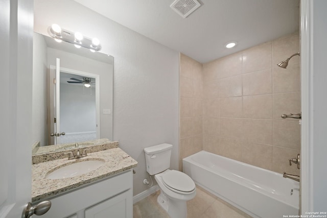 full bathroom with vanity, tiled shower / bath combo, tile patterned flooring, ceiling fan, and toilet