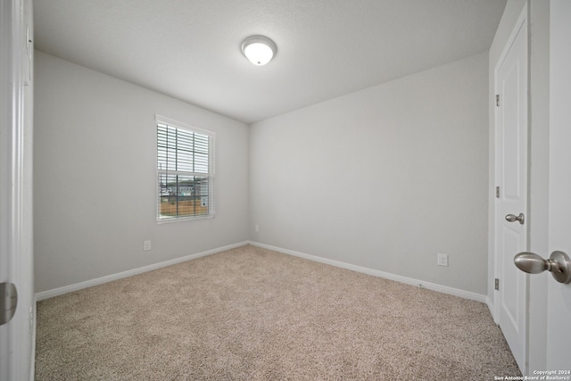 empty room with light colored carpet