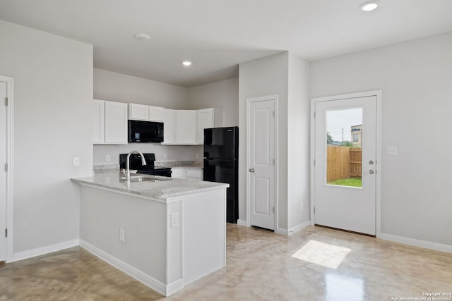 kitchen with light stone counters, white cabinets, sink, kitchen peninsula, and black appliances