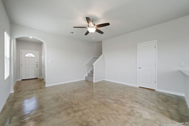 empty room with concrete floors and ceiling fan