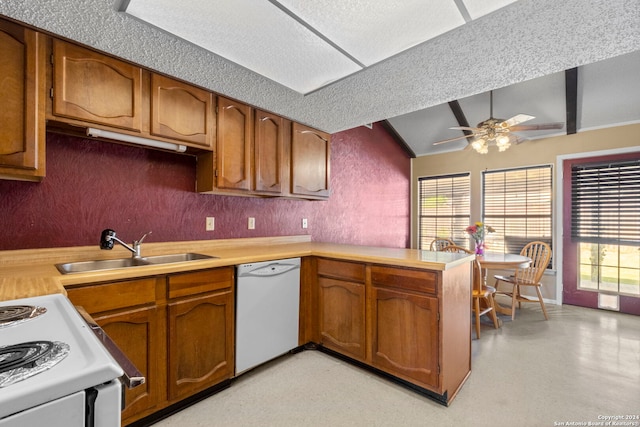 kitchen with ceiling fan, lofted ceiling, sink, kitchen peninsula, and white appliances