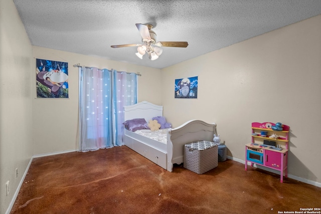 carpeted bedroom with ceiling fan and a textured ceiling