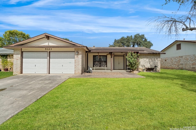 ranch-style house featuring a front yard and a garage