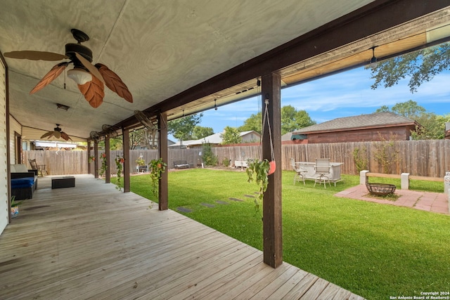 deck featuring a lawn and ceiling fan