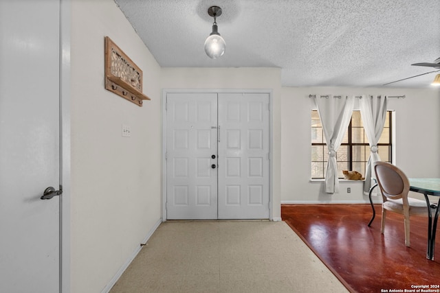 entrance foyer with a textured ceiling and ceiling fan