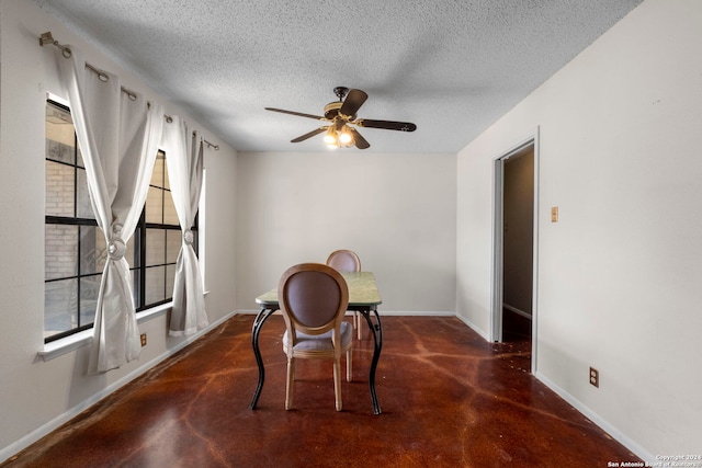 dining space featuring a textured ceiling and ceiling fan