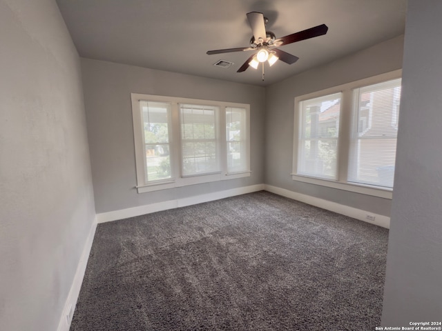 carpeted spare room with ceiling fan