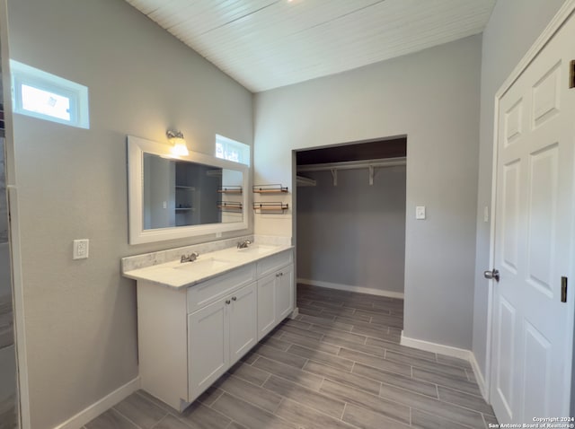 bathroom with a wealth of natural light, hardwood / wood-style floors, and vanity