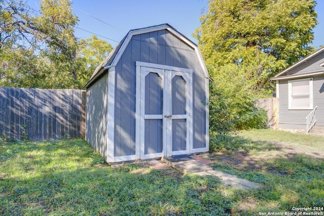 view of outbuilding featuring a lawn