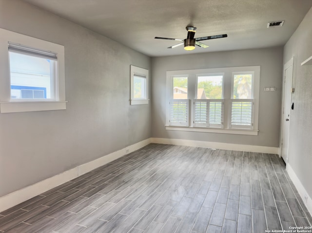 empty room featuring hardwood / wood-style flooring and ceiling fan