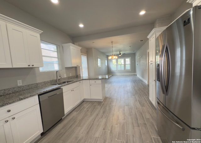 kitchen with white cabinetry, sink, plenty of natural light, and appliances with stainless steel finishes