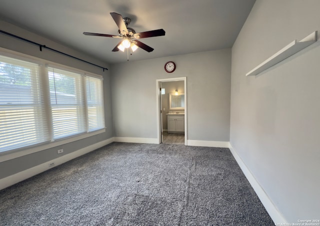 unfurnished bedroom featuring ceiling fan, carpet floors, and ensuite bath