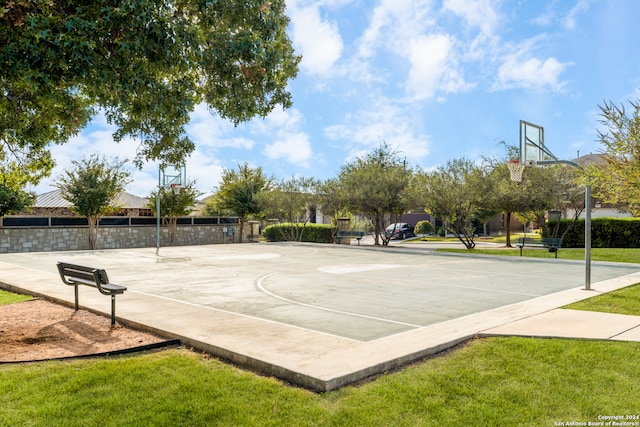 view of sport court featuring a lawn