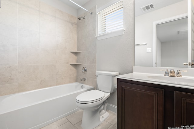 full bathroom featuring toilet, vanity, tile patterned floors, and tiled shower / bath