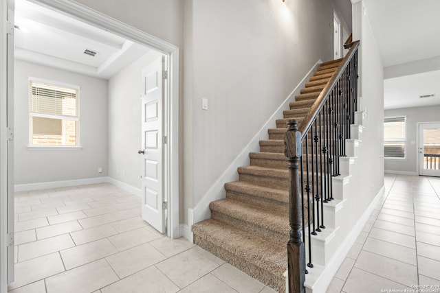 staircase featuring tile patterned floors