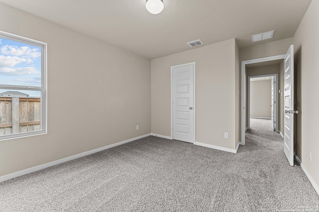 unfurnished bedroom featuring light carpet and a closet