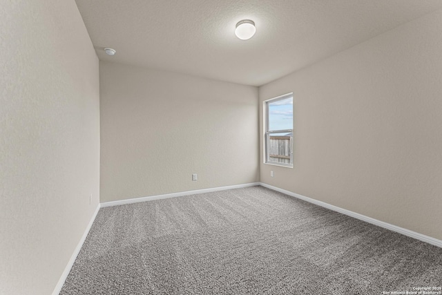 carpeted spare room featuring a textured ceiling