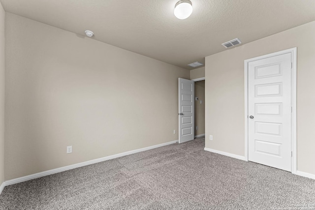 unfurnished bedroom with carpet, a closet, and a textured ceiling