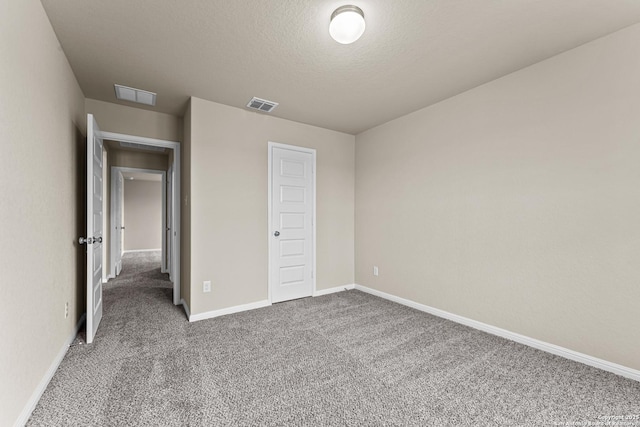 unfurnished bedroom with carpet, a closet, and a textured ceiling