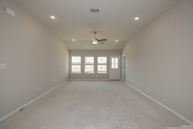 empty room with ceiling fan and vaulted ceiling