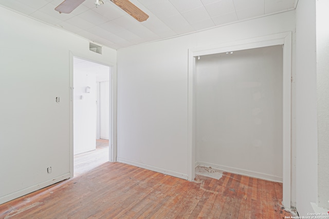 empty room featuring ceiling fan and hardwood / wood-style flooring