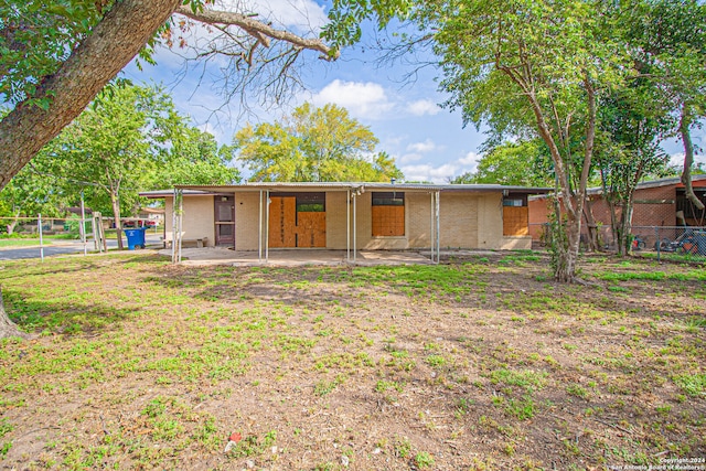 view of front of property featuring a front lawn and a patio area