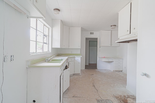 kitchen featuring sink and white cabinets