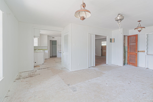 unfurnished living room featuring sink