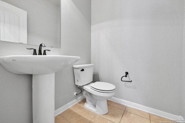 bathroom featuring sink, toilet, and tile patterned floors