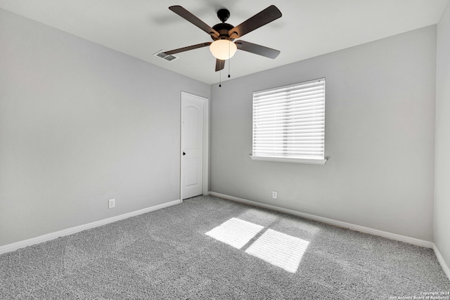 unfurnished room with ceiling fan and carpet floors