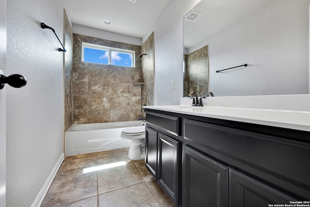 full bathroom featuring tile patterned flooring, vanity, toilet, and tiled shower / bath