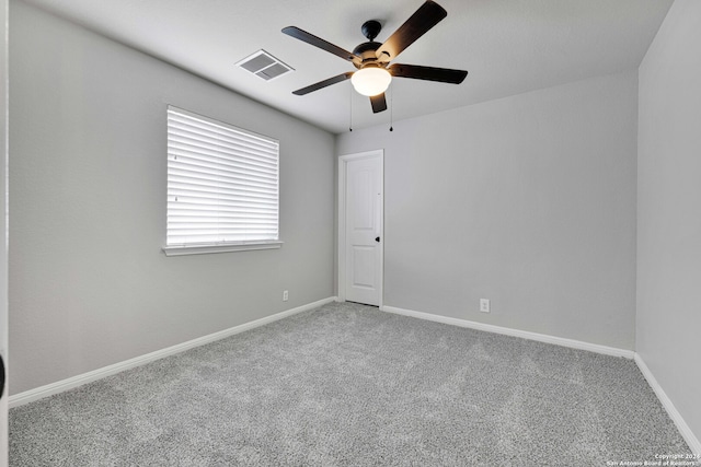 spare room featuring carpet and ceiling fan