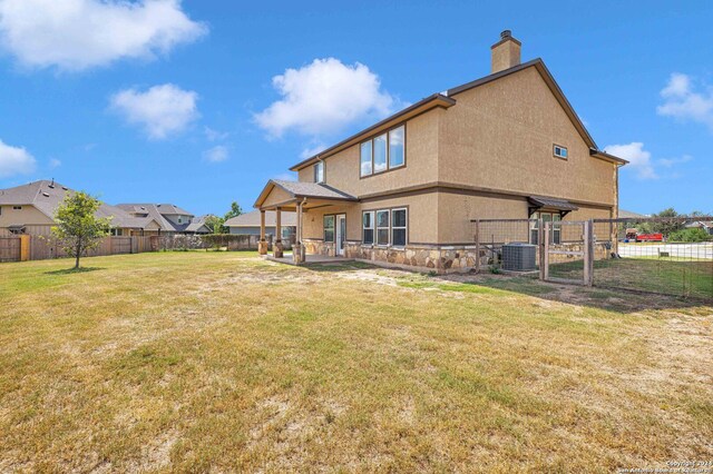 back of property featuring cooling unit, a lawn, and a patio