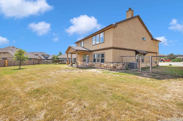 back of property with central air condition unit, a lawn, a fenced backyard, a patio, and stucco siding