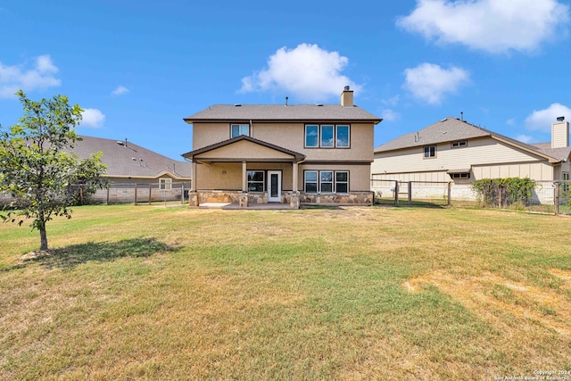 rear view of property with a patio and a yard